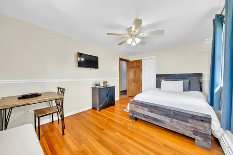 a bedroom with a bed and a flat screen tv