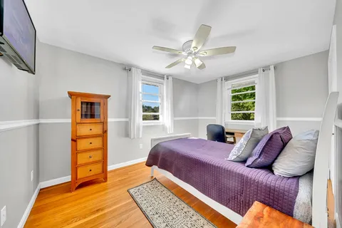 a bedroom with a large bed and a window