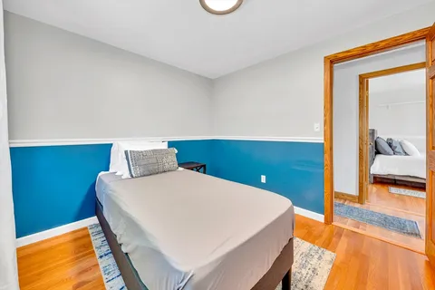 a bedroom with a bed and a potted plant