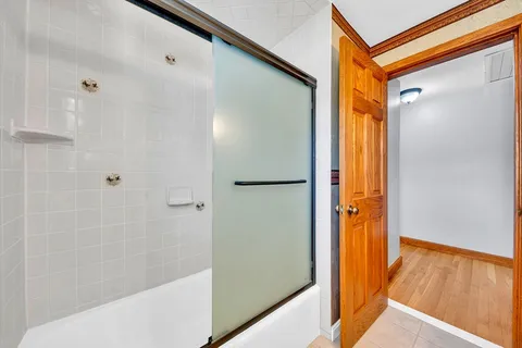 a bathroom with a bathtub and a shower