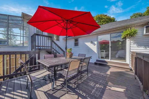 a patio with a table and chairs under an umbrella