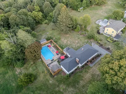 an aerial view of a house with a yard