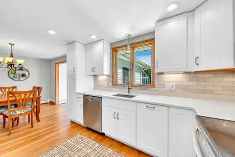 a kitchen with stainless steel appliances granite countertop a sink and cabinets