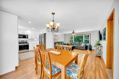 a view of a dining room with furniture a livingroom and chandelier