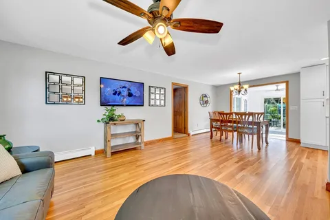a living room with furniture and a wooden floor