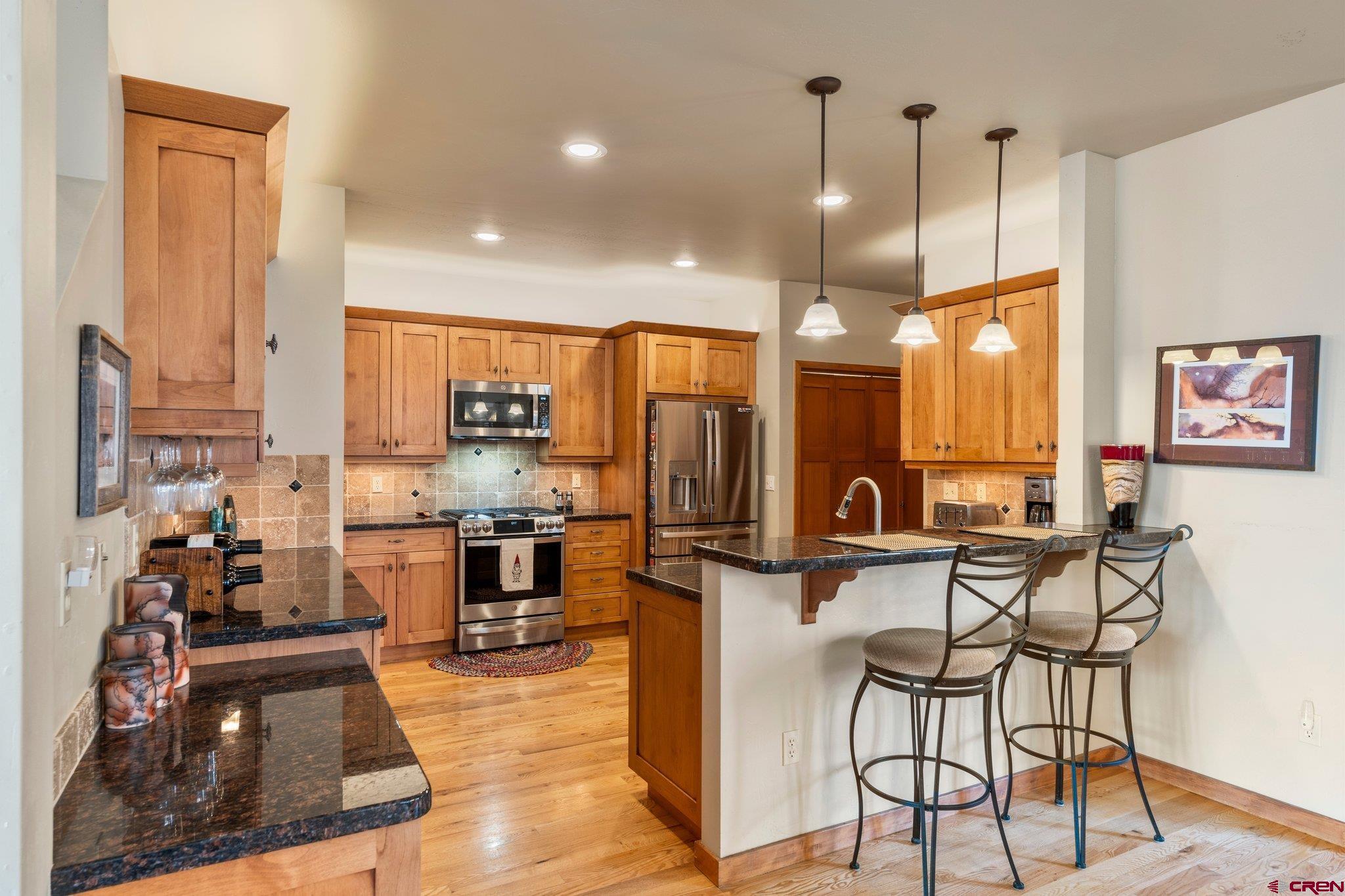 784 Animas View Drive Durango, CO 81301 - Photo 6 of 35 a kitchen with stainless steel appliances kitchen island granite countertop a stove a sink and a refrigerator