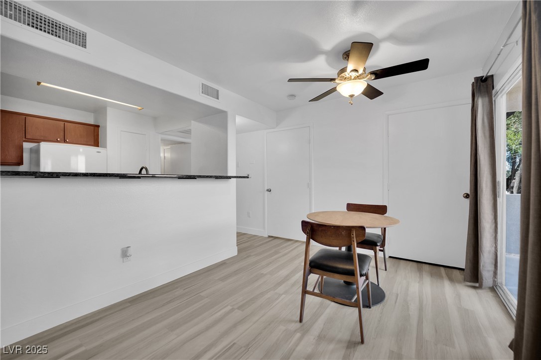 2300 East Silverado Ranch Boulevard, Unit 1189 Las Vegas, NV 89123 - Photo 11 of 27 Dining space with light wood-type flooring and a ceiling fan