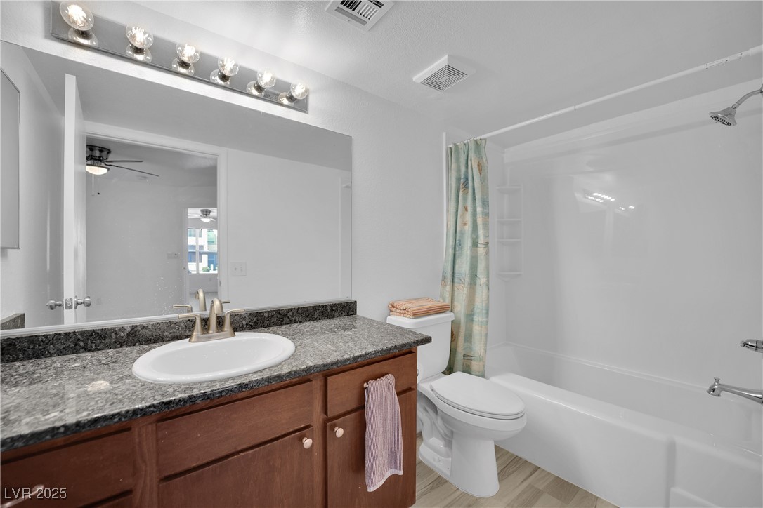2300 East Silverado Ranch Boulevard, Unit 1189 Las Vegas, NV 89123 - Photo 20 of 27 Full bath with shower / bath combination with curtain, vanity, light wood-type flooring, and ceiling fan