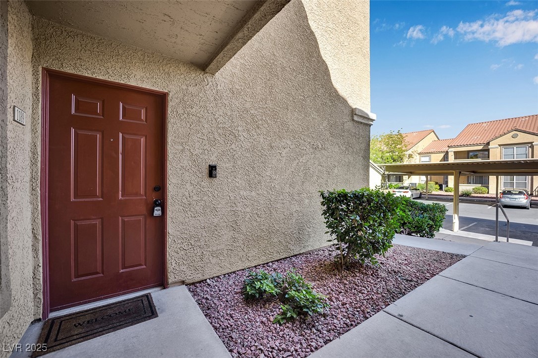 2300 East Silverado Ranch Boulevard, Unit 1189 Las Vegas, NV 89123 - Photo 2 of 27 Doorway to property featuring stucco siding