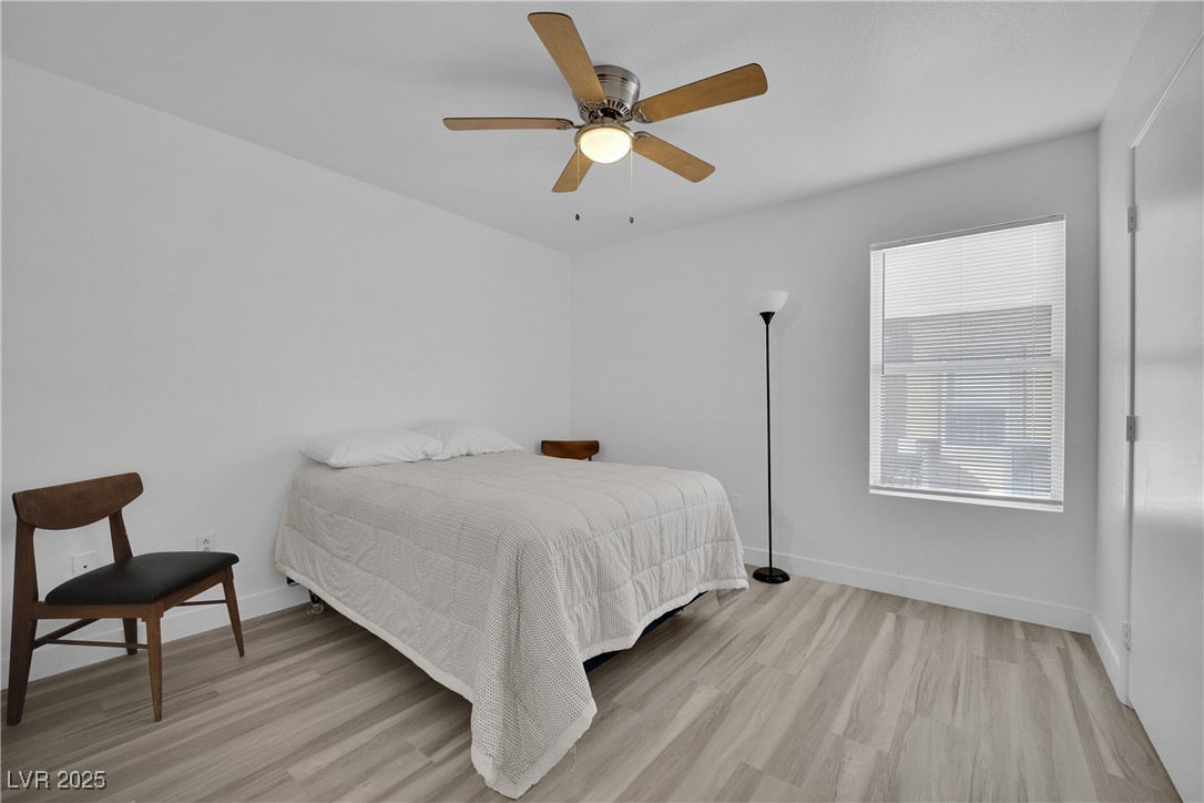 2300 East Silverado Ranch Boulevard, Unit 1189 Las Vegas, NV 89123 - Photo 23 of 27 Bedroom with light wood-type flooring and a ceiling fan