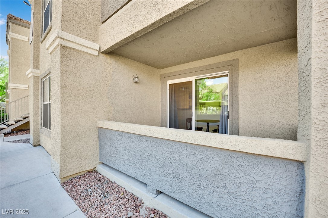 2300 East Silverado Ranch Boulevard, Unit 1189 Las Vegas, NV 89123 - Photo 3 of 27 Doorway to property with stucco siding