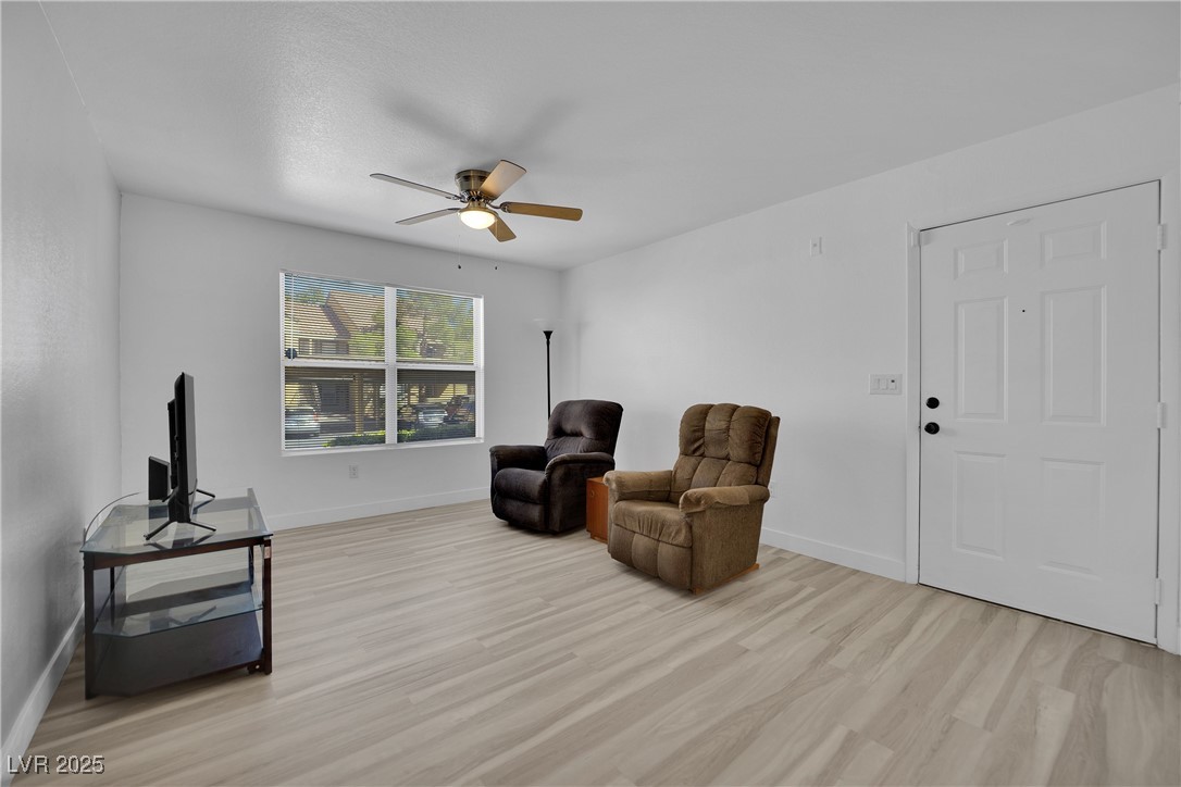 2300 East Silverado Ranch Boulevard, Unit 1189 Las Vegas, NV 89123 - Photo 7 of 27 Sitting room featuring light wood-style flooring and a ceiling fan