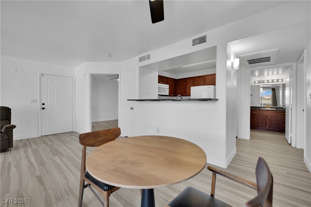 2300 East Silverado Ranch Boulevard, Unit 1189 Las Vegas, NV 89123 - Photo 10 of 27 Dining room featuring ceiling fan and light wood-type flooring