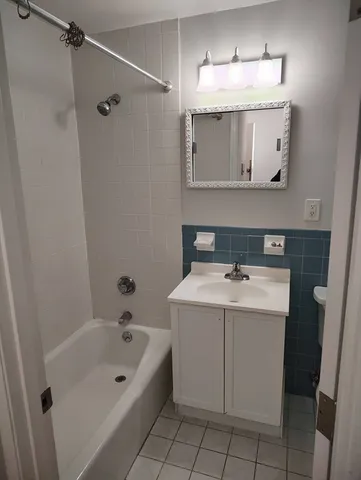 a bathroom with a sink vanity toilet and tub