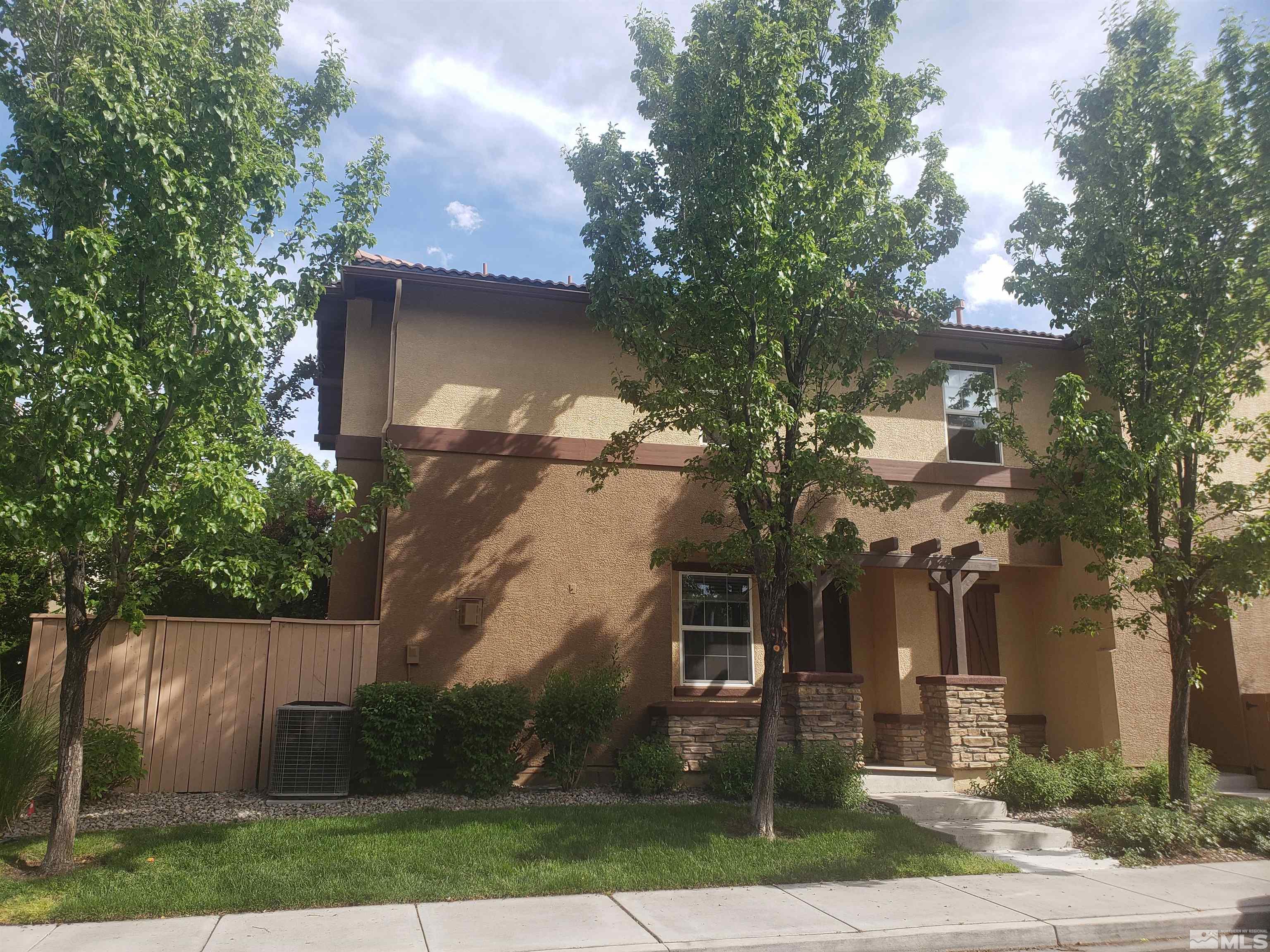 1896 Wind Ranch Road, Unit A Reno, NV 89521 - Photo 1 of 36 a front view of a house with garden