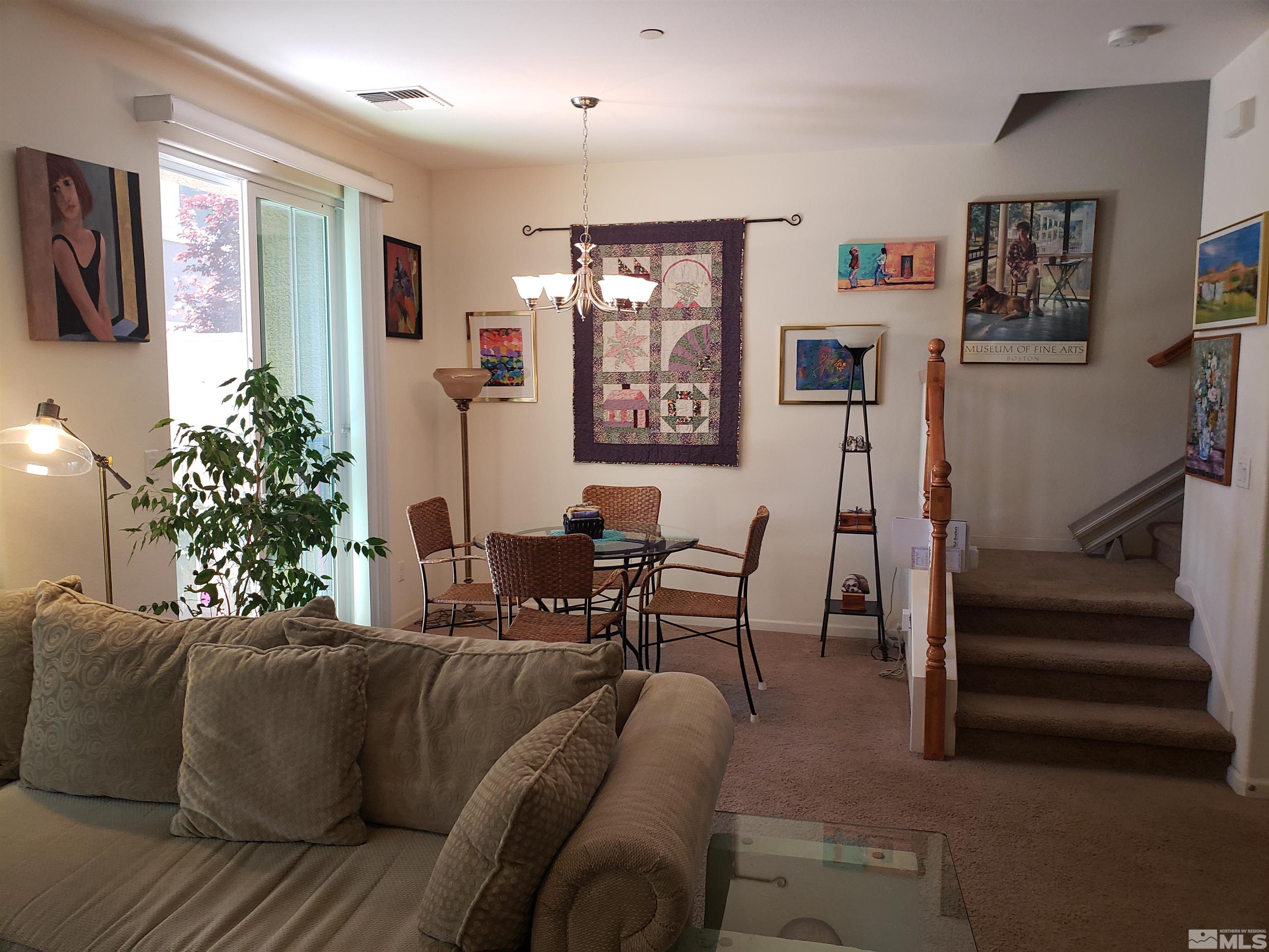 1896 Wind Ranch Road, Unit A Reno, NV 89521 - Photo 11 of 36 a living room with furniture and paintings on the wall