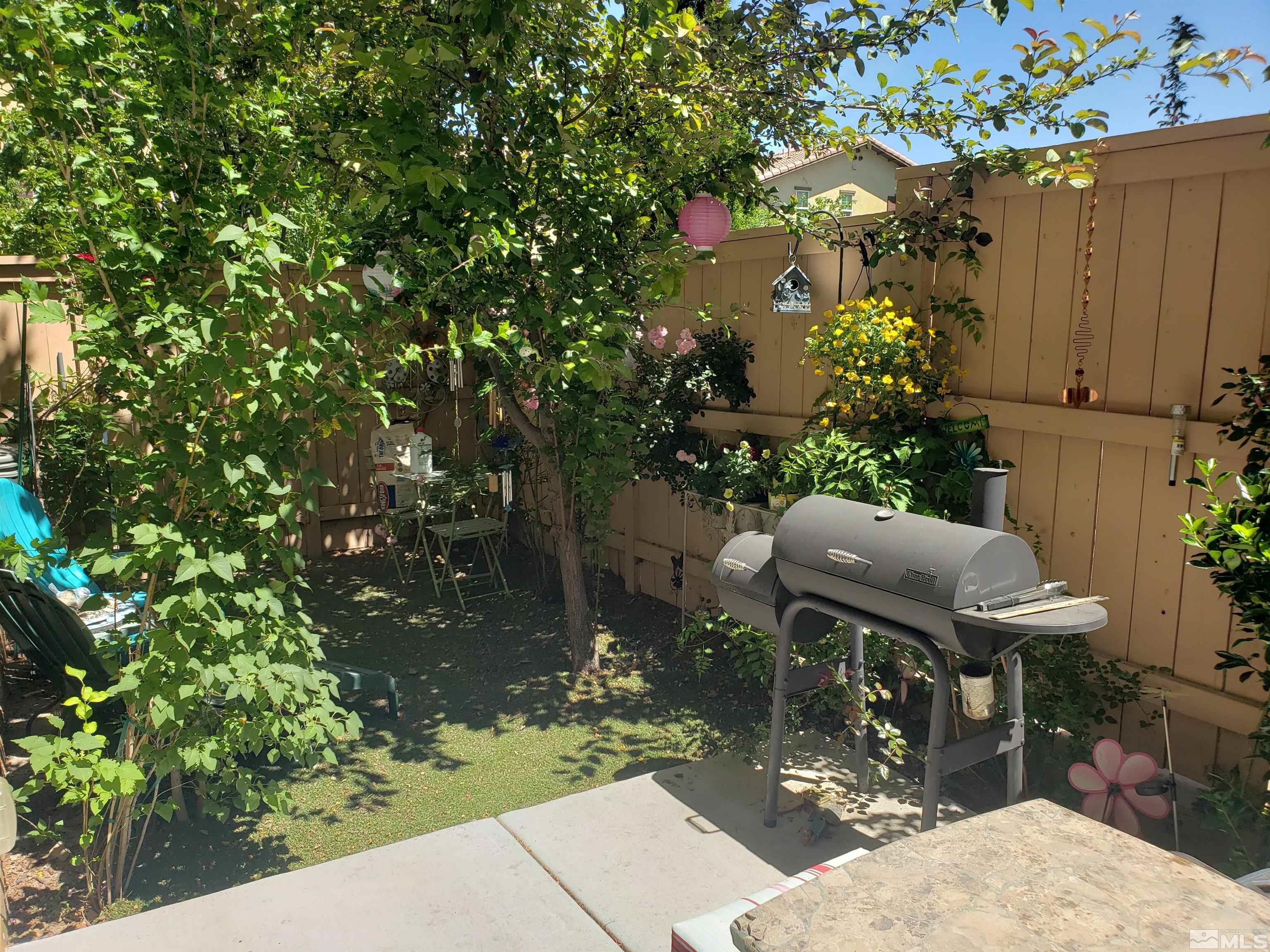 1896 Wind Ranch Road, Unit A Reno, NV 89521 - Photo 14 of 36 a view of backyard with outdoor seating and green space