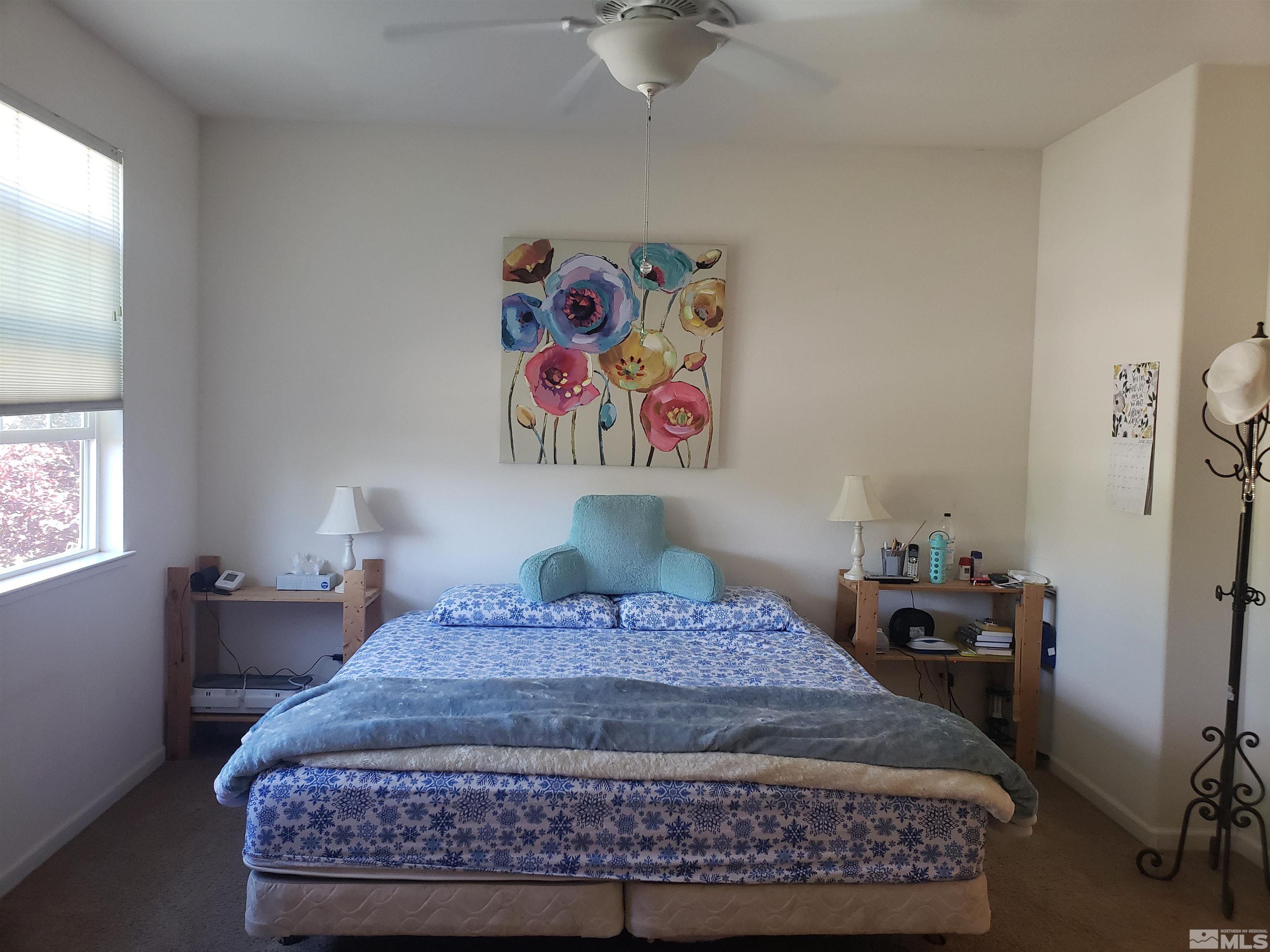 1896 Wind Ranch Road, Unit A Reno, NV 89521 - Photo 22 of 36 a bedroom with a bed and a window