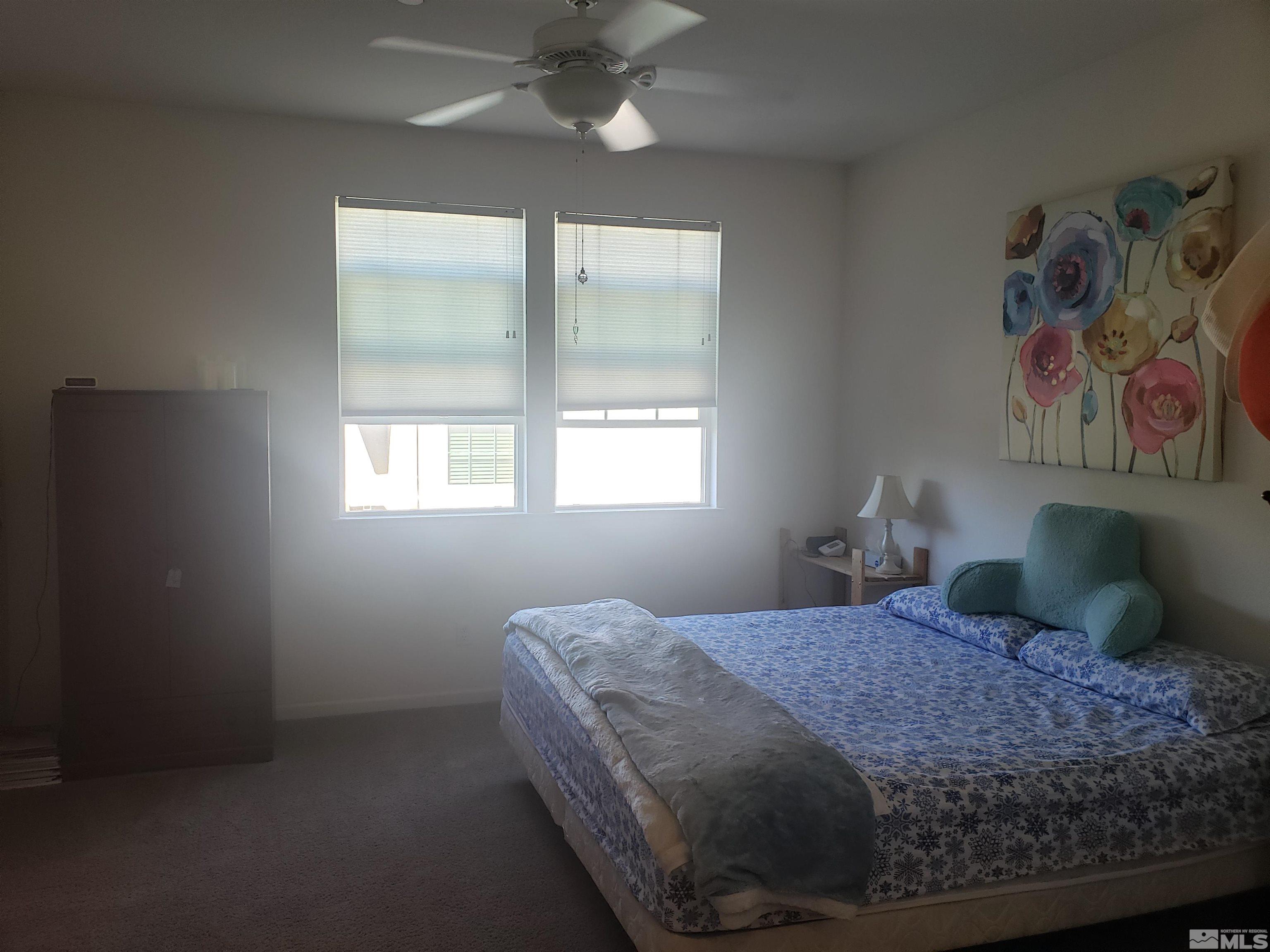 1896 Wind Ranch Road, Unit A Reno, NV 89521 - Photo 23 of 36 a bedroom with a bed and a window