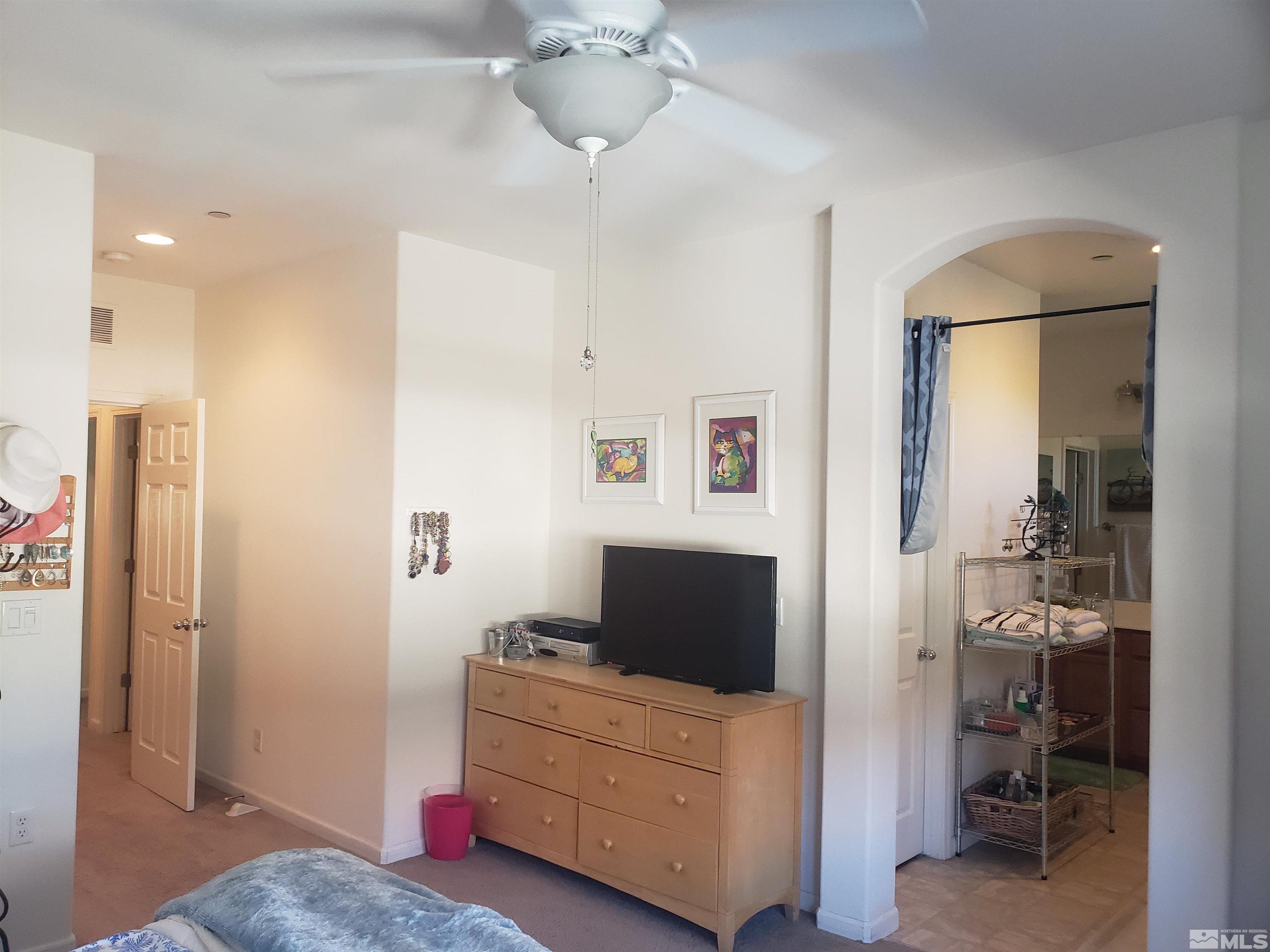 1896 Wind Ranch Road, Unit A Reno, NV 89521 - Photo 24 of 36 a living room with furniture and a flat screen tv