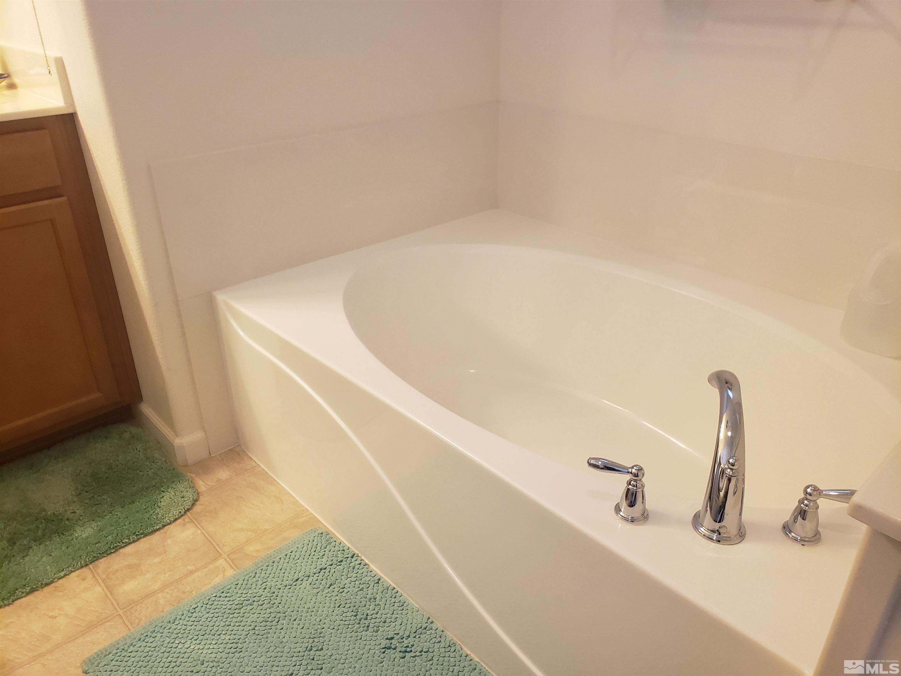 1896 Wind Ranch Road, Unit A Reno, NV 89521 - Photo 26 of 36 a bath tub sitting in a bathroom