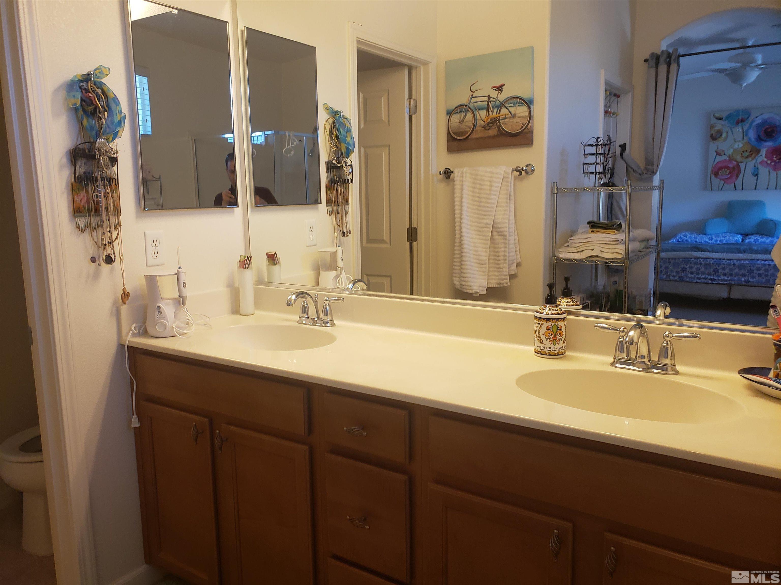 1896 Wind Ranch Road, Unit A Reno, NV 89521 - Photo 27 of 36 a bathroom with a sink and a mirror