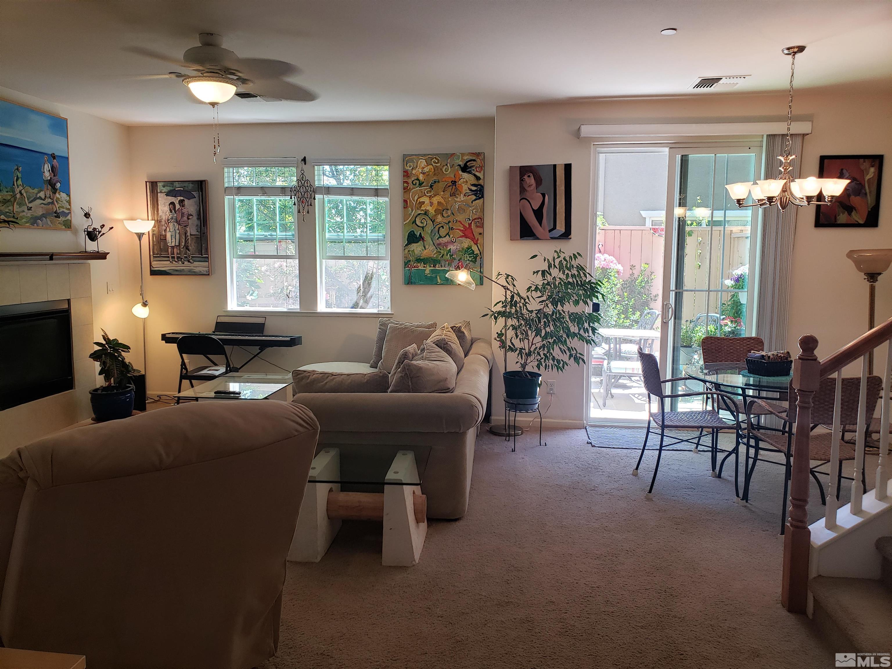 1896 Wind Ranch Road, Unit A Reno, NV 89521 - Photo 3 of 36 a living room with furniture a large window and a fireplace