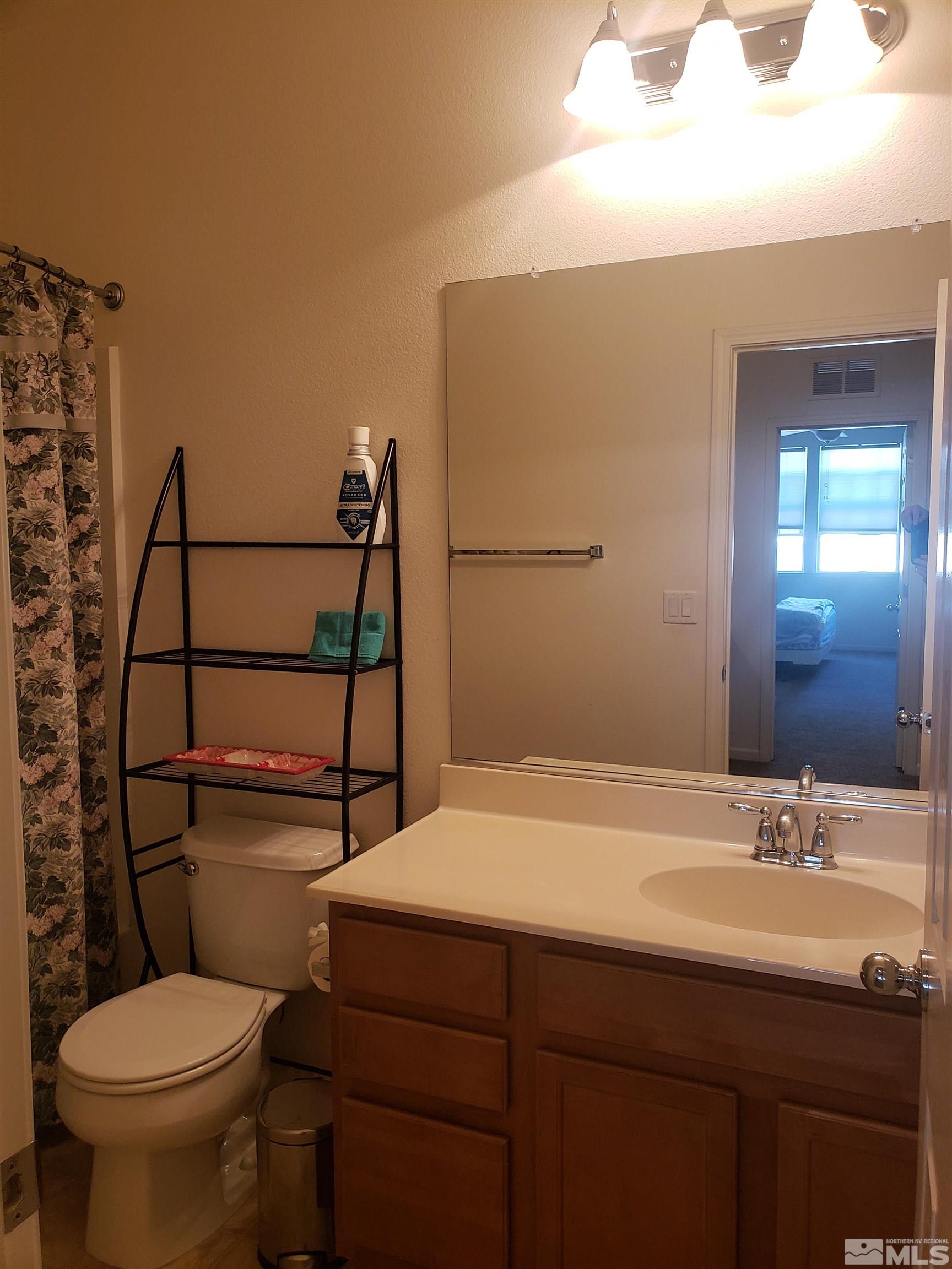 1896 Wind Ranch Road, Unit A Reno, NV 89521 - Photo 31 of 36 a bathroom with a sink toilet and shower