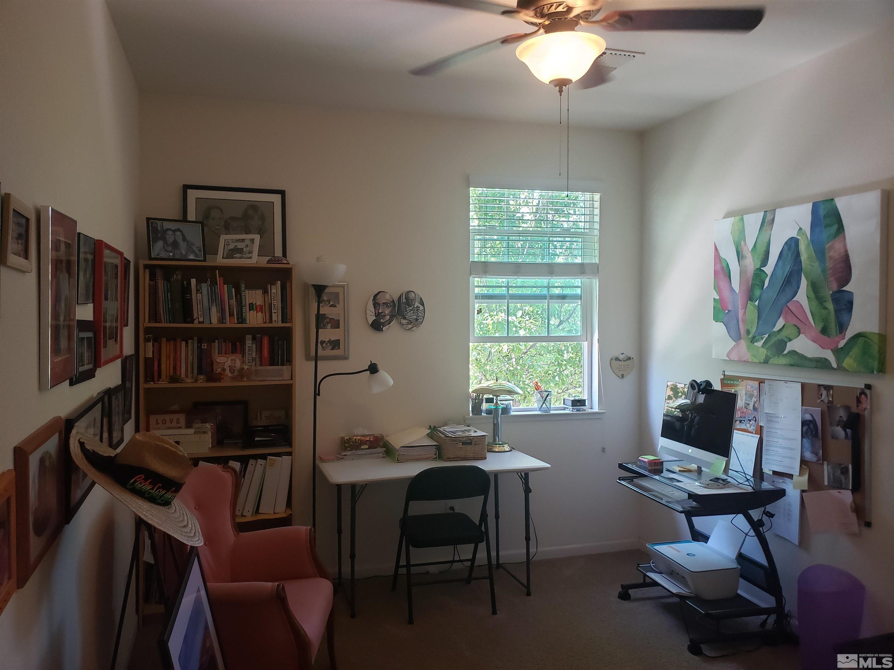 1896 Wind Ranch Road, Unit A Reno, NV 89521 - Photo 32 of 36 a livingroom with workspace window and a couch