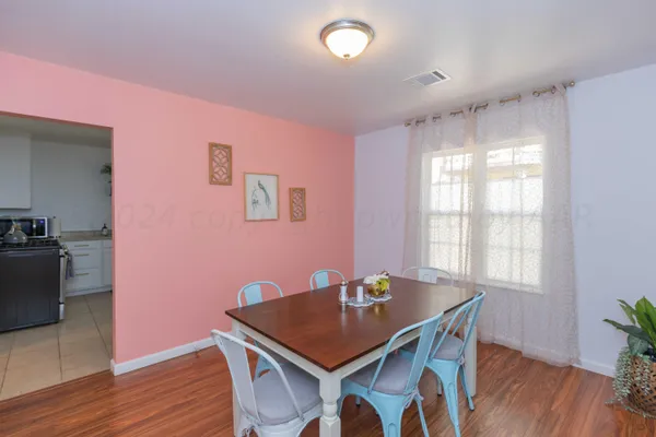 a view of a dining room with furniture window and wooden floor