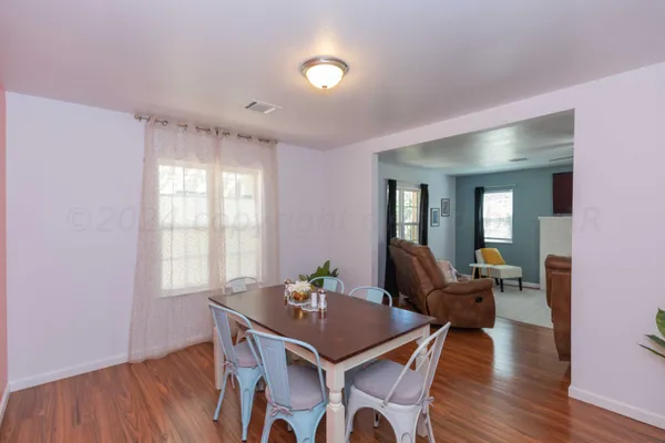 a view of a dining room with furniture and wooden floor