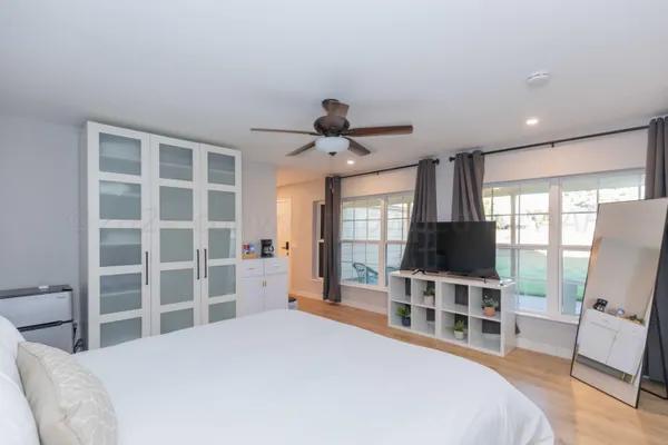 a bedroom with a bed and a flat screen tv