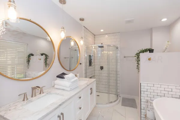 a bathroom with a sink mirror toilet and shower