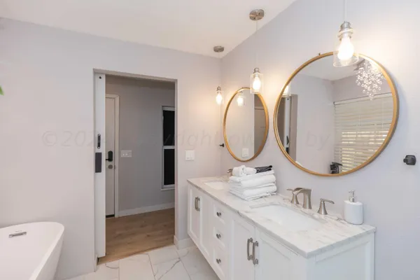 a bathroom with a double vanity sink mirror and a toilet