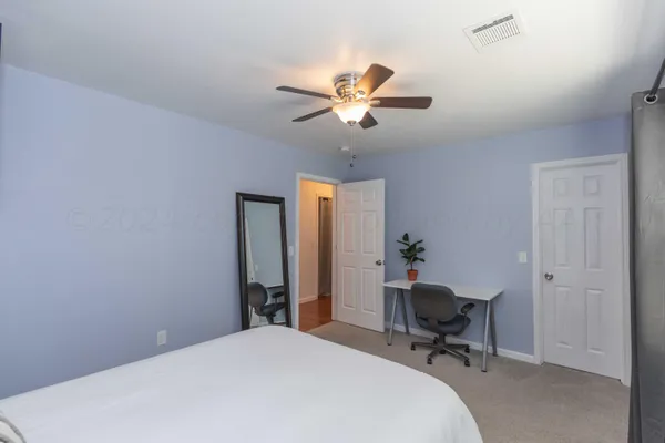 a workspace with chandelier fan and a window