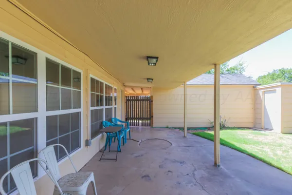 a backyard of a house with table and chairs