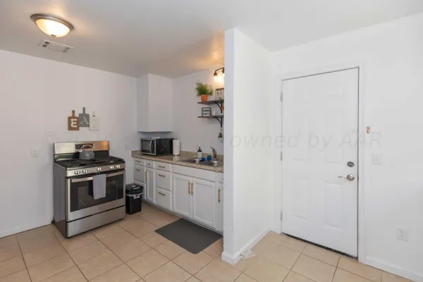a kitchen with a stove and a refrigerator