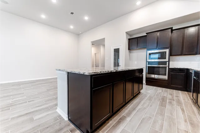 an empty room with a empty space and windows