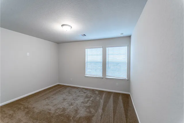 a bathroom with a sink a toilet and a large mirror