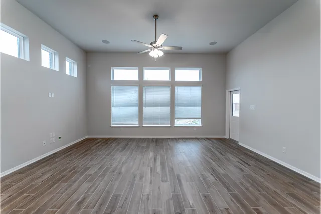 a view of a room with wooden floor and a window