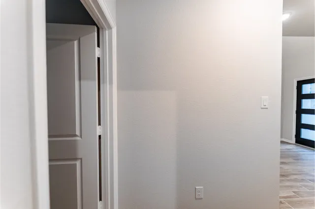 a view of kitchen with stainless steel appliances wooden floor and refrigerator