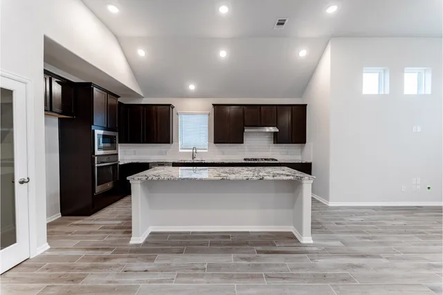 an empty room with a empty space and windows