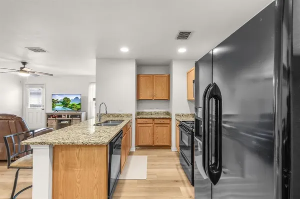 a kitchen with a refrigerator and a sink