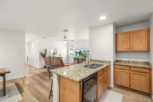 a kitchen that has a sink and a stove in it