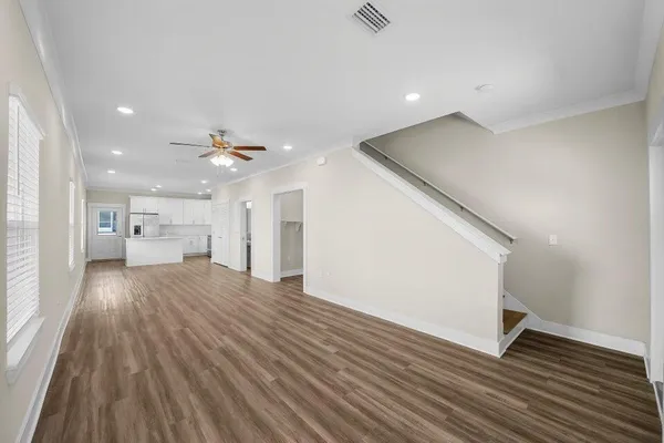 a view of empty room with wooden floor