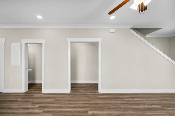 a view of a room with wooden floor