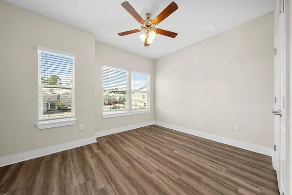 wooden floor in an empty room with a window