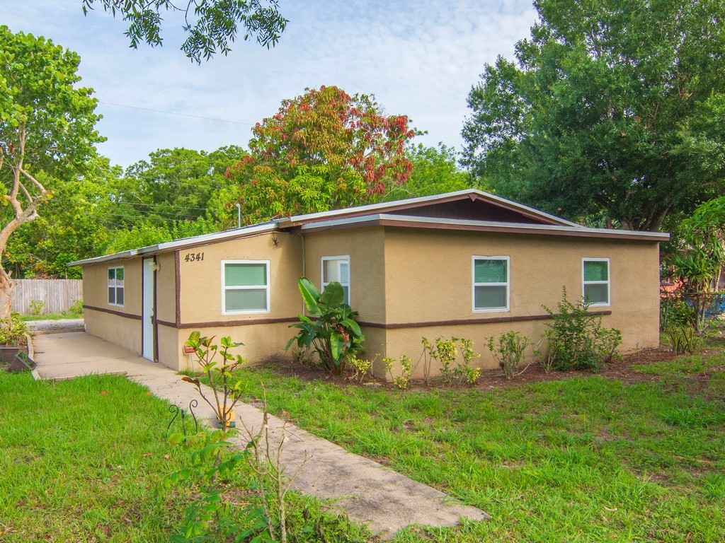 4341 35th Avenue Vero Beach, FL 32967 - Photo 1 of 25 a front view of house with yard and green space