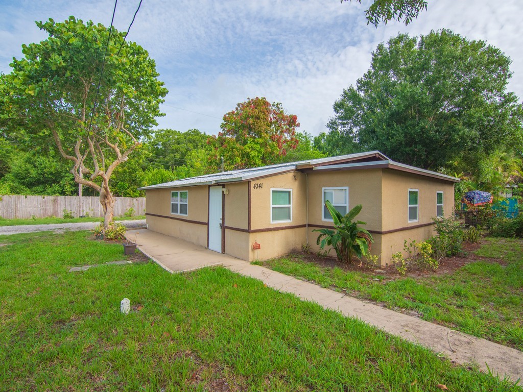 4341 35th Avenue Vero Beach, FL 32967 - Photo 17 of 25 a front view of house with yard and green space