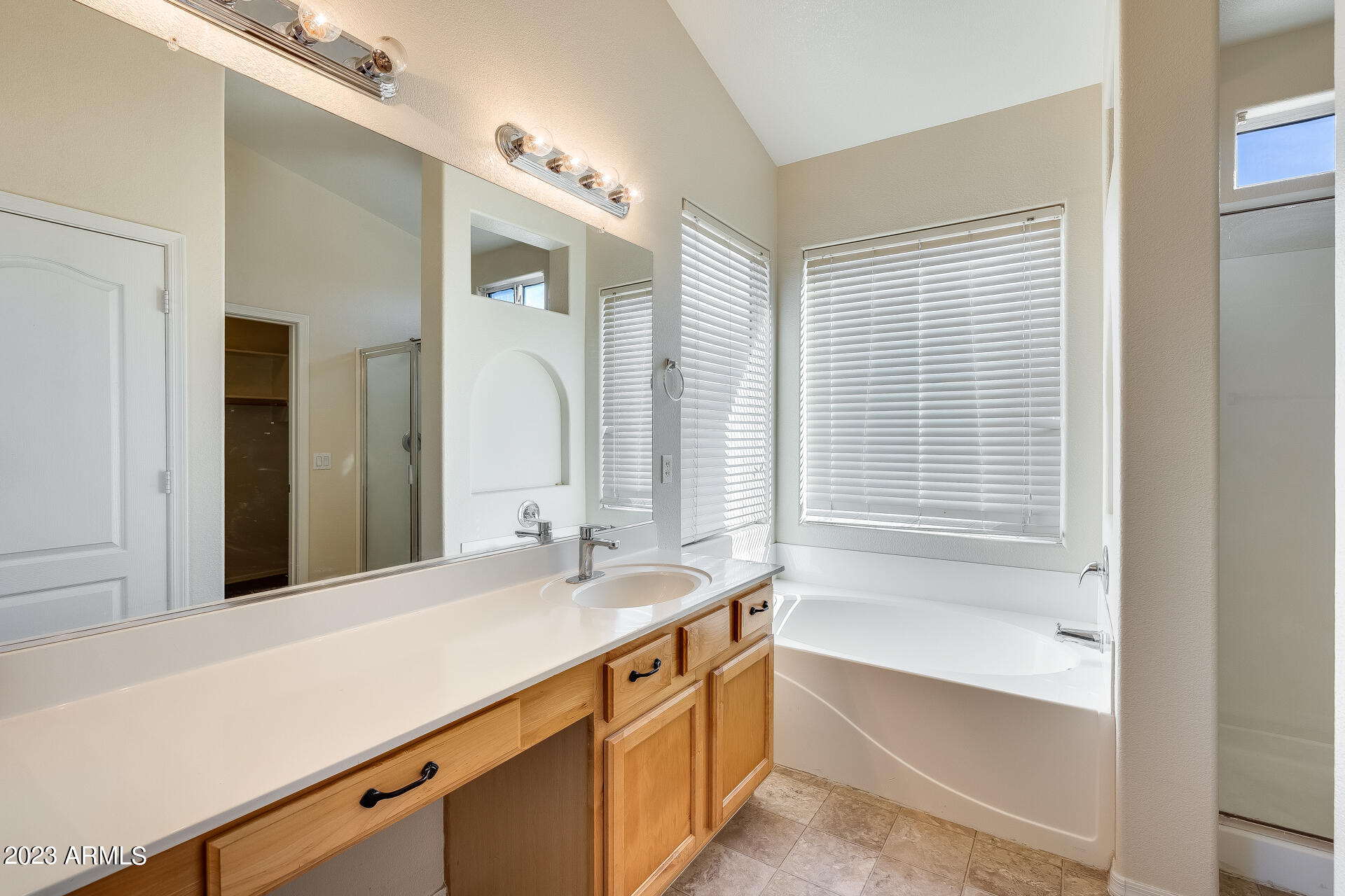 3244 West Maldonado Road Phoenix, AZ 85041 - Photo 32 of 43 a bathroom with a tub sink and mirror